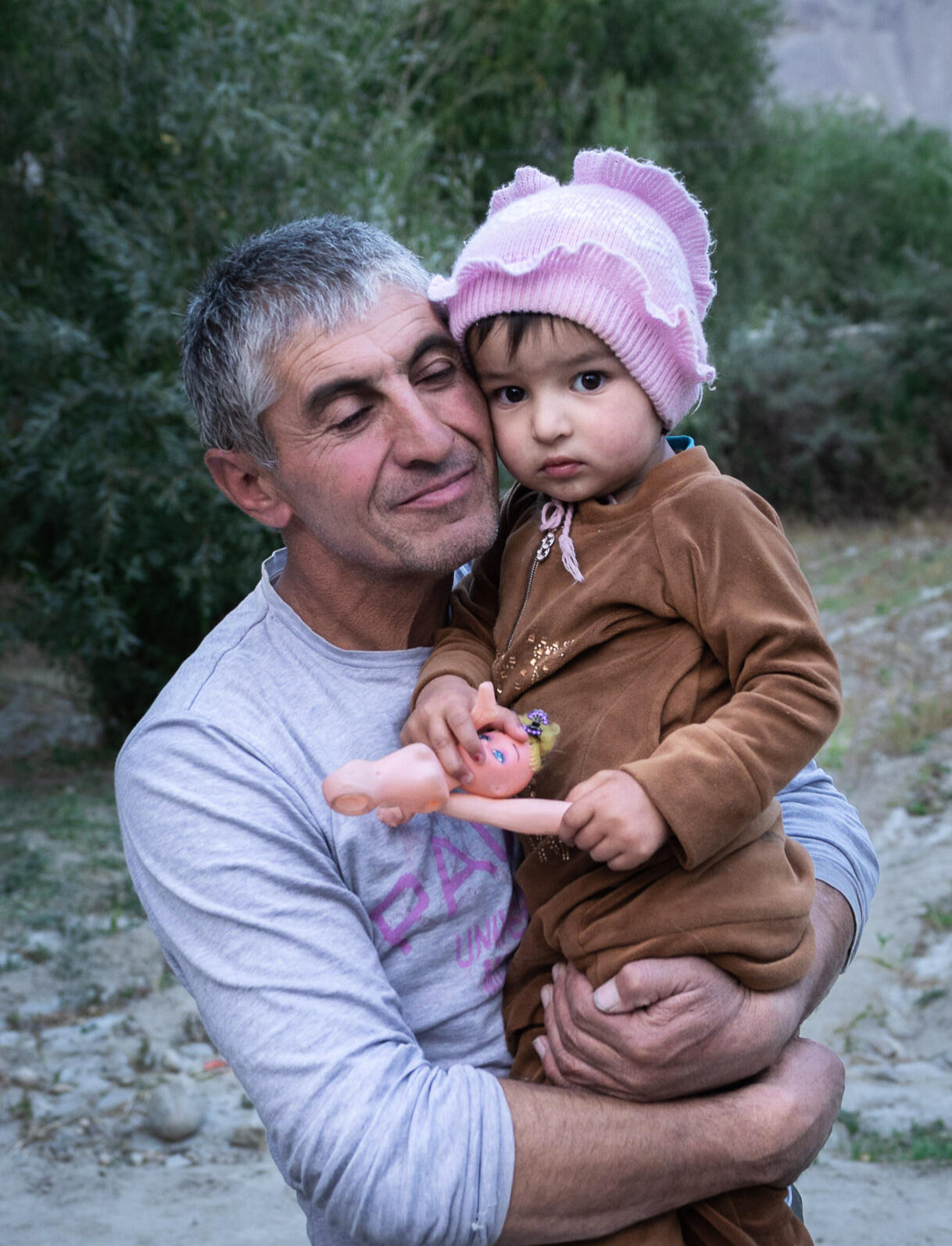 frontier-discovery-project-father-hugs-daughter.jpg Village father snuggles with his youngest daughter