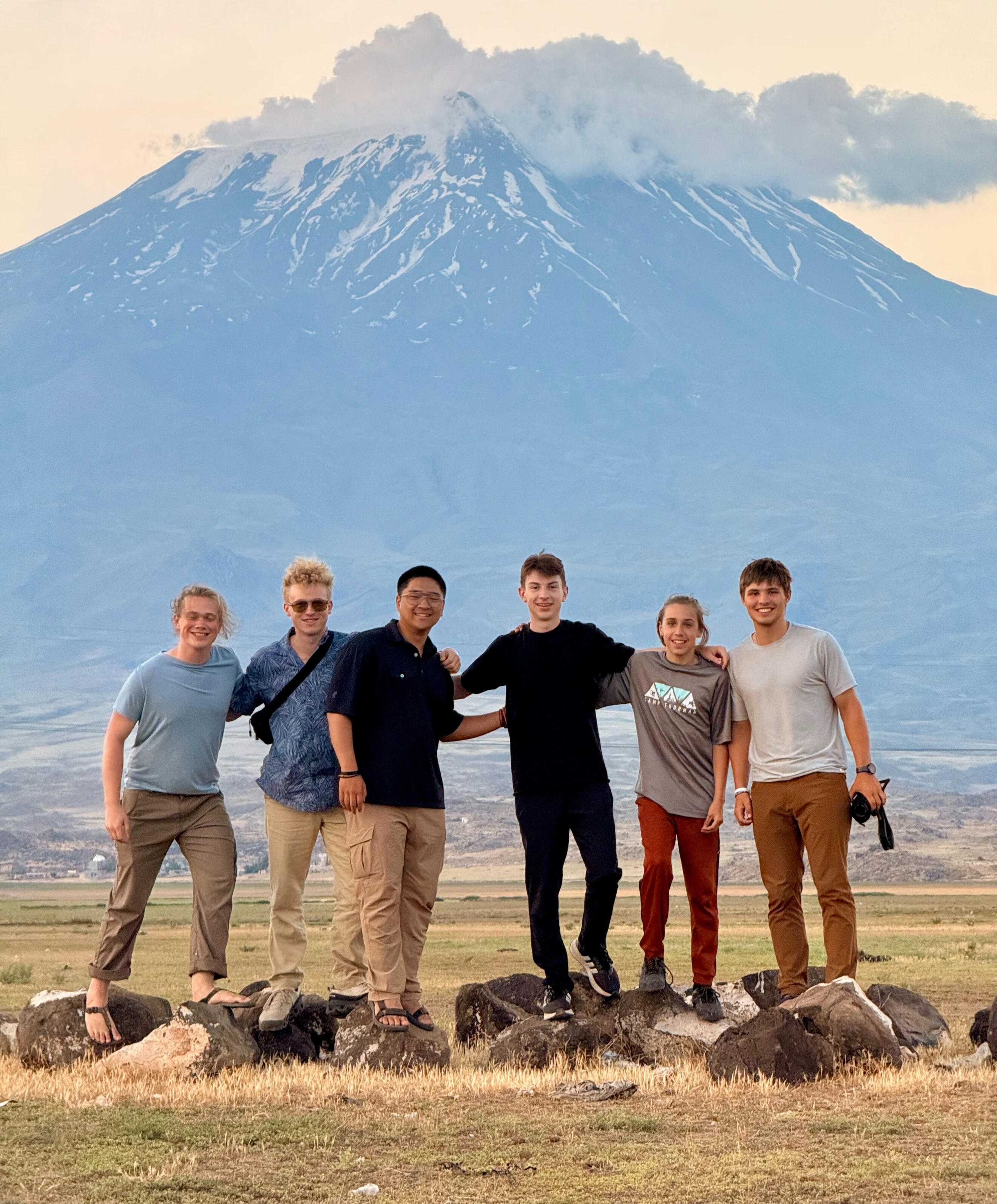 Young team stands together in front of mountain