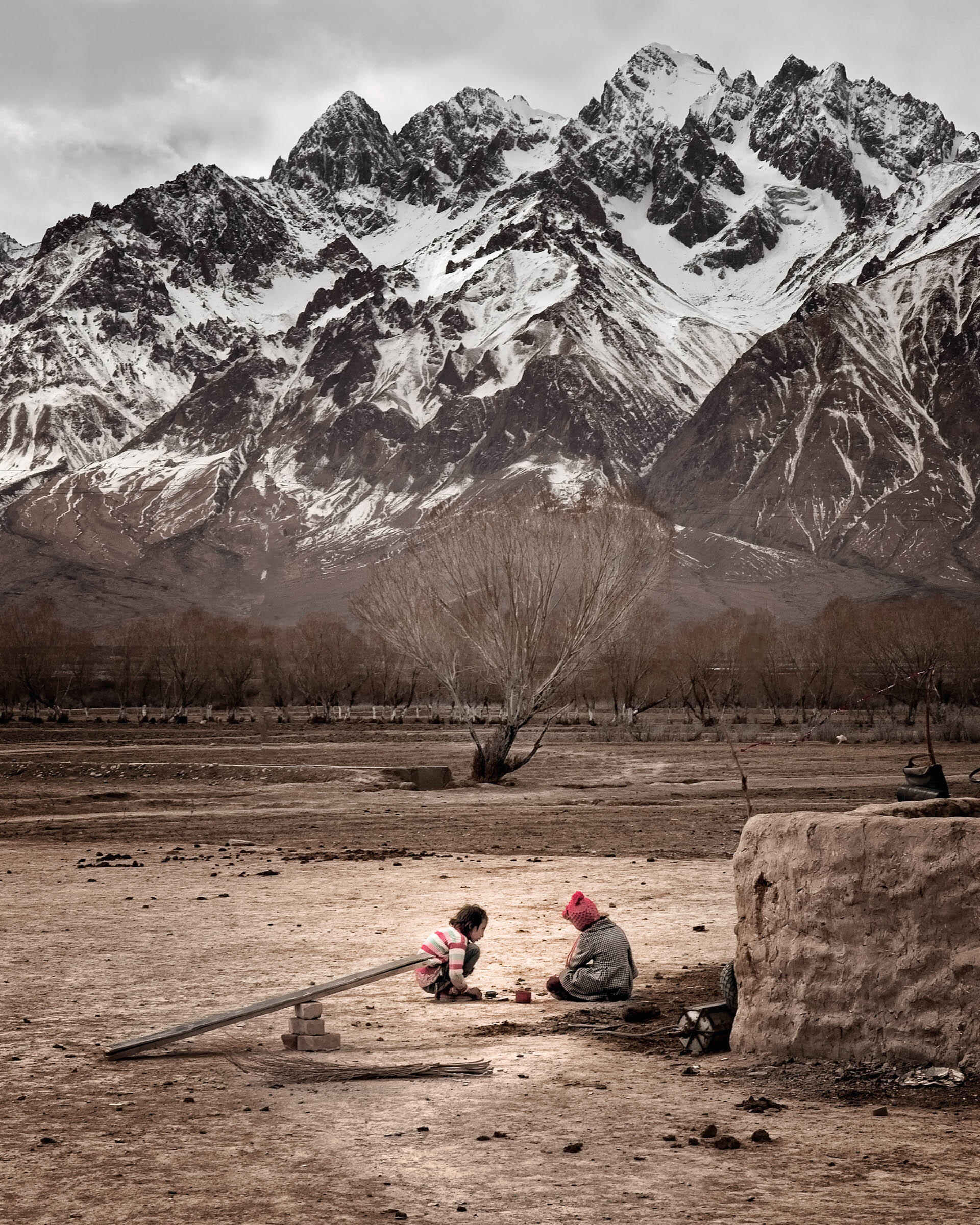 frontier-discovery-project-hero-girls-play.jpg Two village girls play together in front of mountain at their home