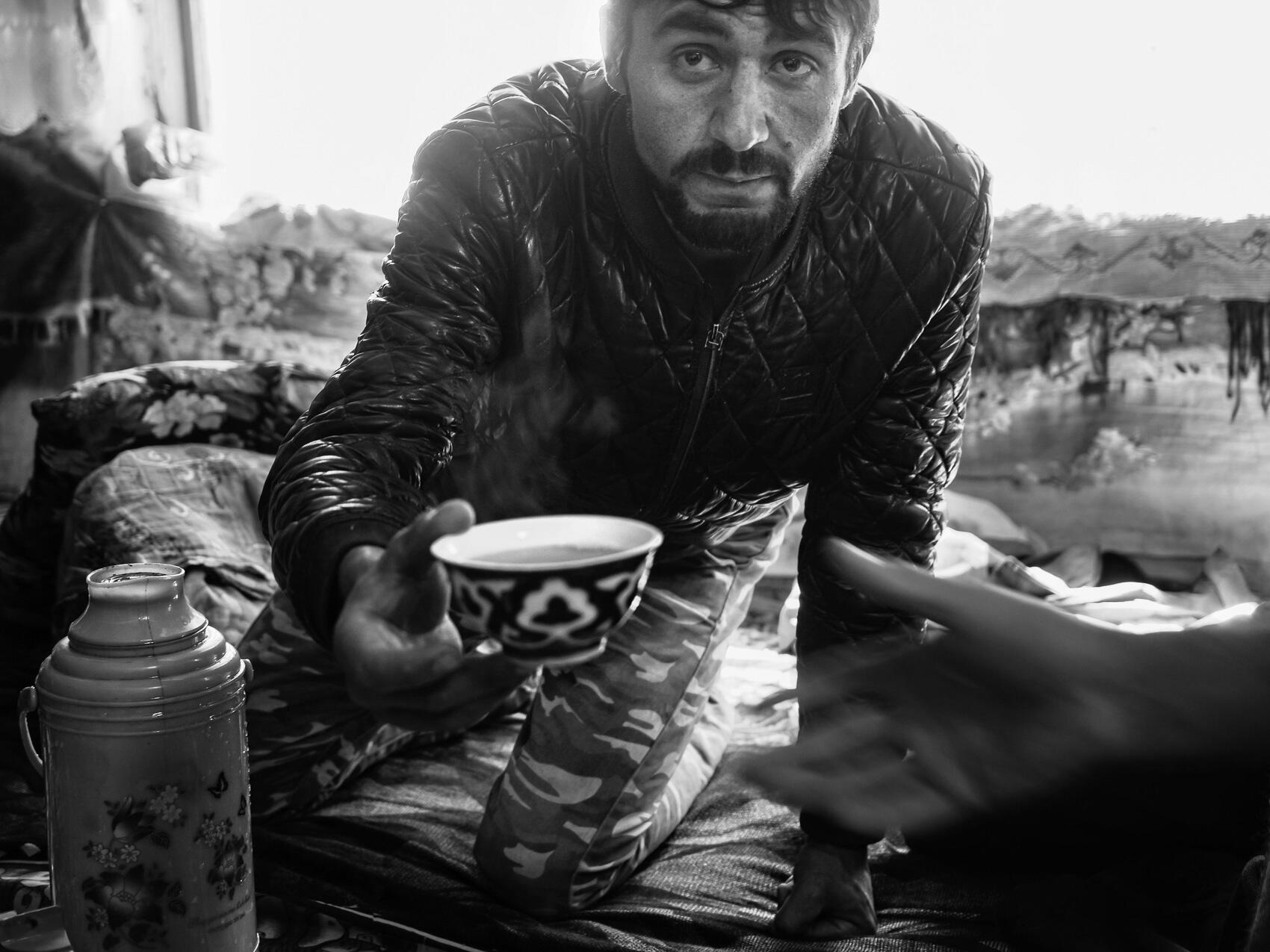 frontier-discovery-project-man-offers-tea.jpg man offers tea to a guest in his home